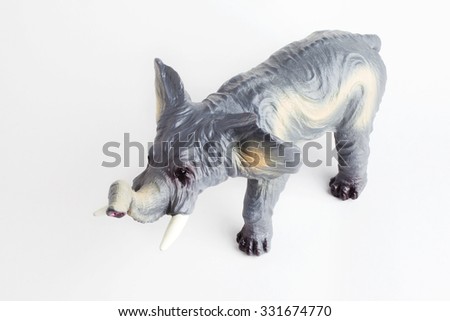Plastic elephant toy isolated in front of a white background, angle view.