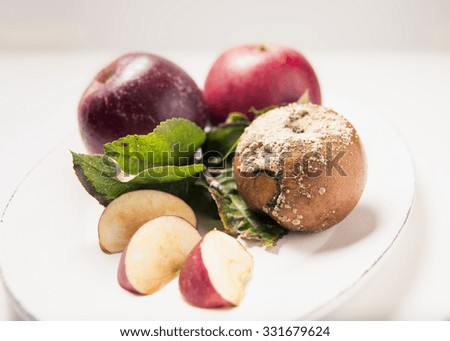 Apple plate with rotten apple