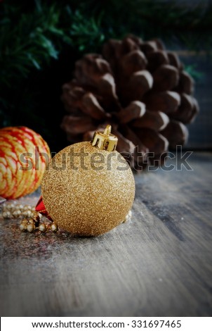 Christmas decorations on a background of trees and cones on a wooden surface