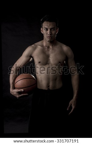 Portrait of Asian Basketball Player In Black Scene