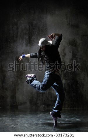modern style dancer posing on dirty grunge background