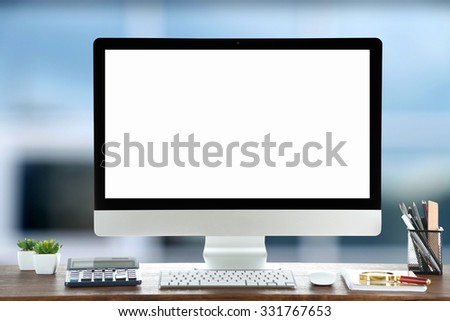 Computer on wooden table on abstract background