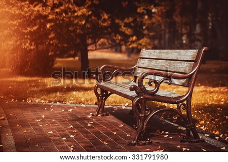 old wooden bench in city park. natural vintage autumn background