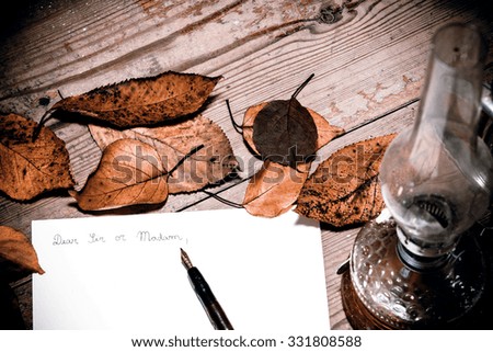 Old fashioned letter with a pen and leafs