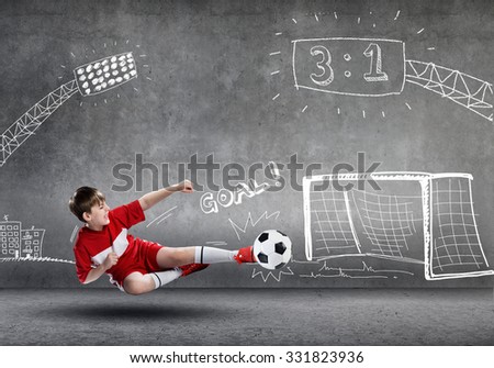 School aged boy on sketched background playing football 