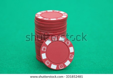 stack of red poker chips on casino table