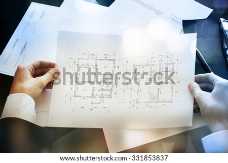 Businessman sitting at his desk reading documents
