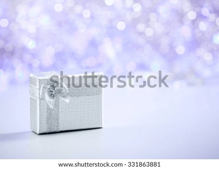 Beautiful Christmas gift on glitter background with copy space. Merry Christmas and Happy New Year