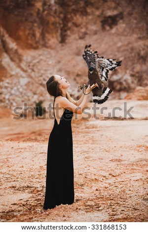 Amazing picture of exploring woman,discover the world,american eagle on grand canyon.young girl in black dress standing in the mountains,image making from action camera.gopro camera image 