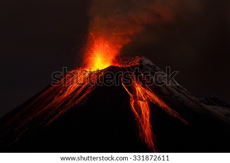 A small active volcano in Ecuador erupting lava and fire, creating a dark explosion amidst the mountain landscape. volcanology magma Royalty-Free Stock Photo #331872611