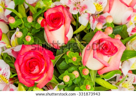 Stunning flower arrangement featuring three large roses,crafted with exquisite precision and artistry.