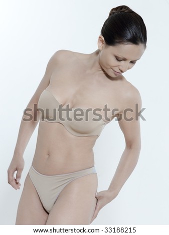 asian woman on isolated background looking at her body
