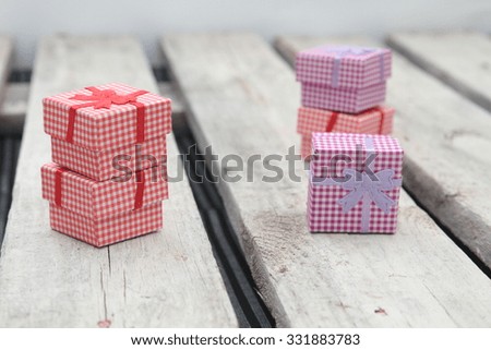 Boxes of red and pink gifts, white tree in the background.
Special gift background