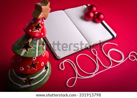 Christmas decorations on hot red background. Christmas and 2016 New Year theme. Place for your text, wishes, logo. Mock up. Vignetted.
