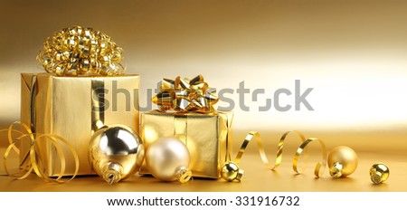 Golden gift boxes with decoration on abstract background