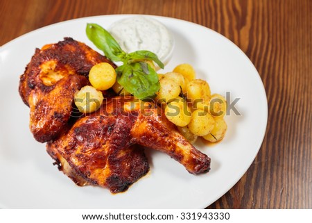 
Fried potatoes with chicken legs. Hearty and delicious. Beautiful exhibition dish in white plate. Photo for culinary magazines, posters and websites.