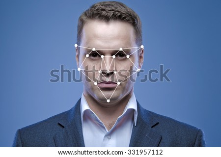 Biometric verification - young man face recognition Royalty-Free Stock Photo #331957112
