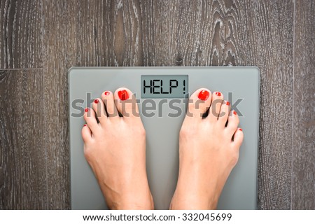 Lose weight concept with person on a scale measuring kilograms Royalty-Free Stock Photo #332045699