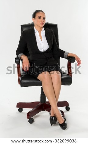 Serious Hispanic young woman dark brown in business formal outfit
