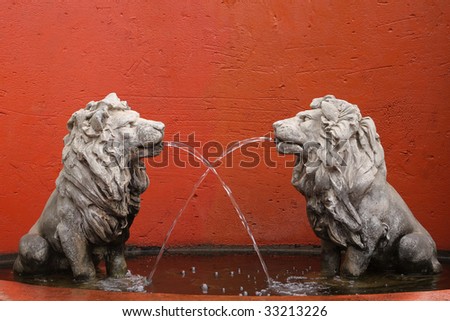 Concrete lions in water fountain