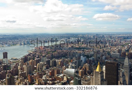 New York City, Cityscape view of Manhattan with skyscrapers and blue sky by day.