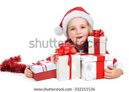 little girl in red santa cap with christmas presents 