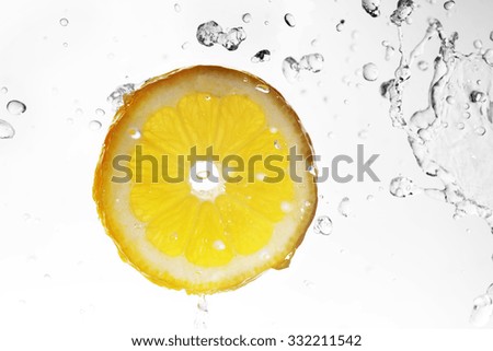 slice of lemon in  water with bubbles