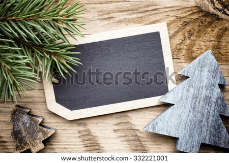 Christmas blank tags on wooden table.