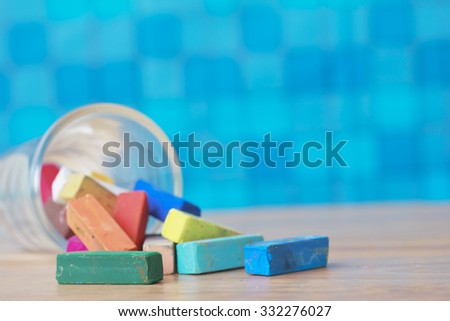 Stock Photo:
Still life with empty blackboard and colored chalks