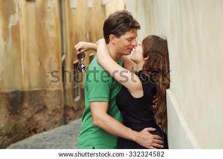 young couple in love walking on a street of European city. journey through Austria