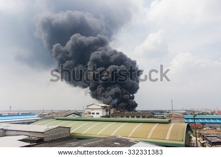 Fire burning and black smoke over the Factory. Royalty-Free Stock Photo #332331383
