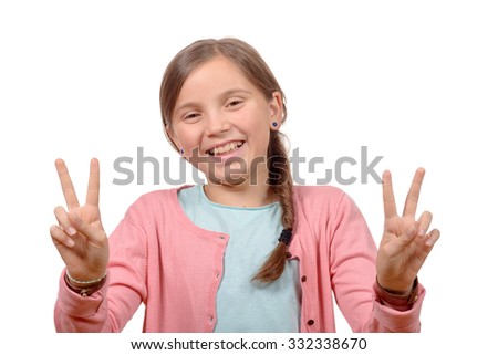 young girl showing her hands by doing victory gesture on white background