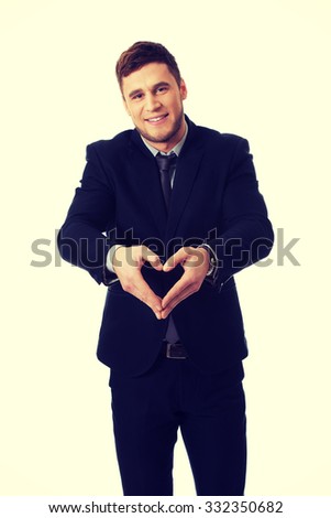 Businessmn making heart shape by his hands.