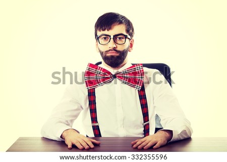 Funny old fashioned man sitting by a desk.