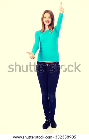 Happy teenager showing thumbs up with both hands