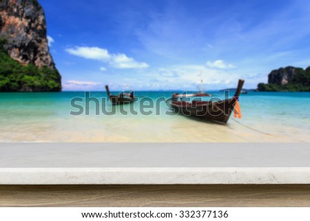 Empty top of natural stone table and view of tropical beach background. Can use for product display