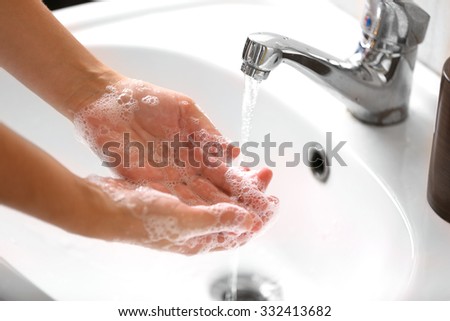 Washing of hands with soap under running water Royalty-Free Stock Photo #332413682