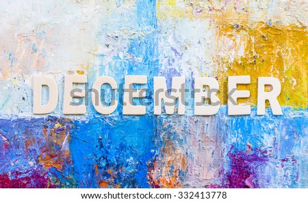 The word " December " design by white letterpress on painted background