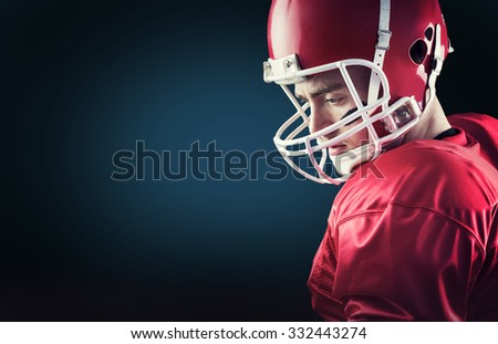 Concentrated american football player against blue background with vignette