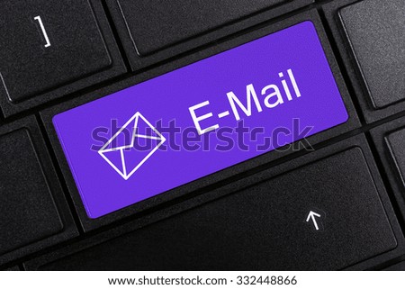 bright e-mail button on laptop keyboard closeup