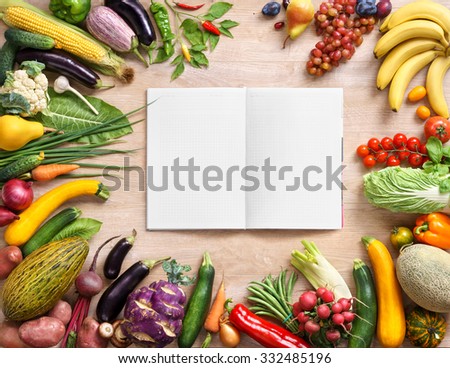 Purchase list. Space for text / studio photography of open blank ring bound notebook surrounded by a fresh vegetables on wooden table. High resolution product. Copy space