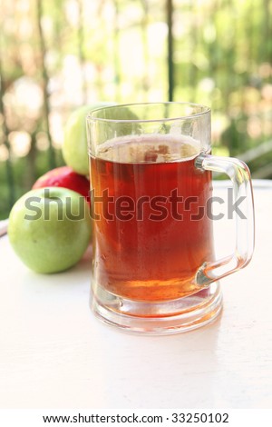 apple juice inside big glass with raw apples
