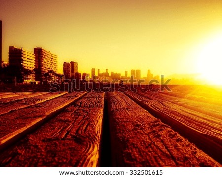 Looking across wooden walkway to Benidorm beach at sunrise