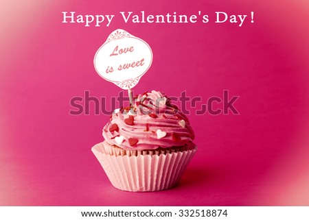 Delicious cupcake with inscription on pink background