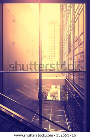 Vintage stylized picture of modern office at sunset, New York City, USA.