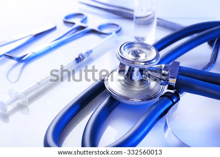 Stethoscope with medical equipment on white background, close up Royalty-Free Stock Photo #332560013