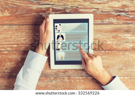 business, education, people, internet and technology concept - close up of male hands pointing finger to webpage article on tablet pc computer screen and coffee cup at table