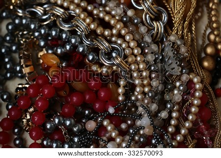 Beautiful elegant fashionable bijouterie collection of bead necklaces chains glass and golden lying together on white background, horizontal picture