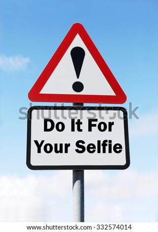 A red and white triangular road sign with a Do It For Your Selfie play on words concept against a partly cloudy sky.