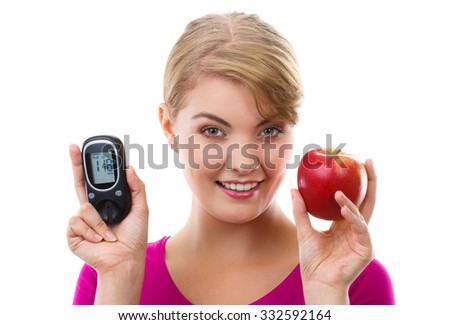 Happy woman holding glucose meter with positive result of measurement sugar level and fresh ripe apple, concept of diabetes, checking sugar level, white background Royalty-Free Stock Photo #332592164